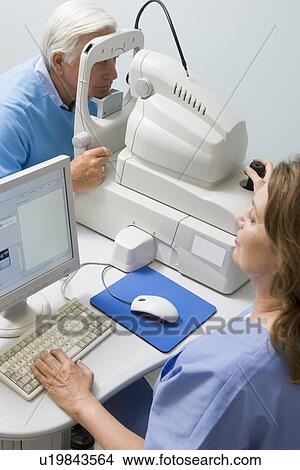 Picture - Nurse Checking Patient's Eyes. Fotosearch