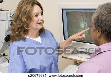 Stock Photography - Nurse Explaining Eye Exam Results To Patient. Fotosearch