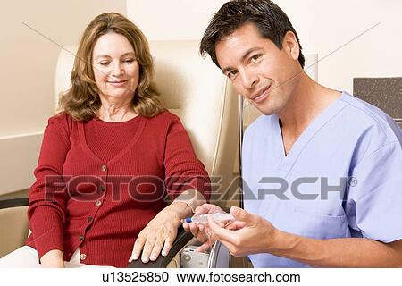 Stock Image - Nurse Giving Patient An Injection. Fotosearch