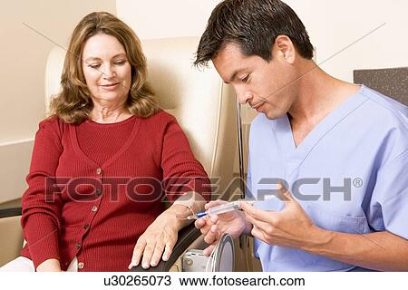 Stock Image - Nurse Giving Patient An Injection. Fotosearch
