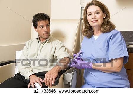 Stock Photograph - Nurse Giving Patient Injection Through Tube. Fotosearch