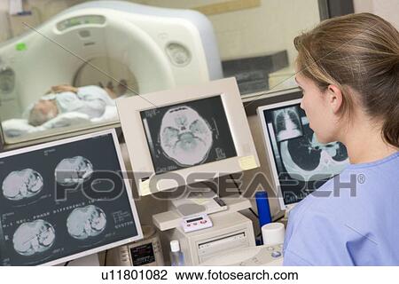 Nurse Monitoring Patient Having A Computerized Axial Tomography (CAT) Scan View Large Photo Image Stock Image - Nurse Monitoring Patient Having A Computerized Axial Tomography (CAT) Scan. Fotosearch