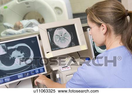 Stock Photography - Nurse Monitoring Patient Having A Computerized Axial Tomography (CAT) Scan. Fotosearch
