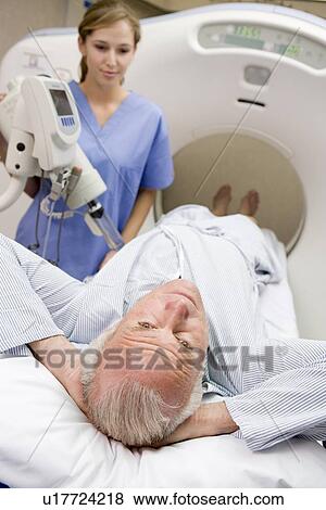 Stock Photo - Nurse With Patient As They Prepare For A Computerized Axial Tomography (CAT) Scan. Fotosearch