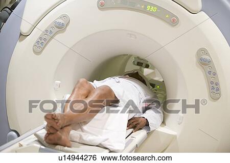 Stock Photograph - Nurse With Patient As They Prepare For A Computerized Axial Tomography (CAT) Scan. Fotosearch