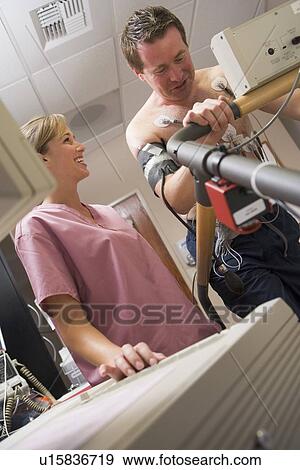 Stock Photo - Nurse With Patient During Health Check. Fotosearch
