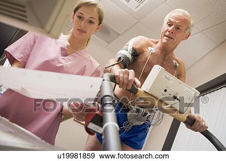 Nurse With Patient During Health Check View Large Photo Image Stock Photo - Nurse With Patient During Health Check. Fotosearch