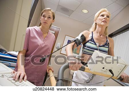 Nurse With Patient During Health Check View Large Photo Image Stock Photo - Nurse With Patient During Health Check. Fotosearch