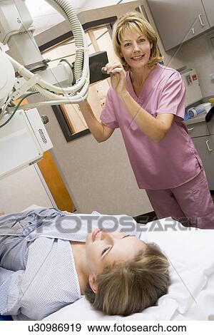 Stock Photo - Nurse With Patient Having An X-Ray. Fotosearch