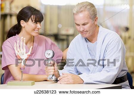 Stock Image - Nurse With Patient In Rehabilitation. Fotosearch