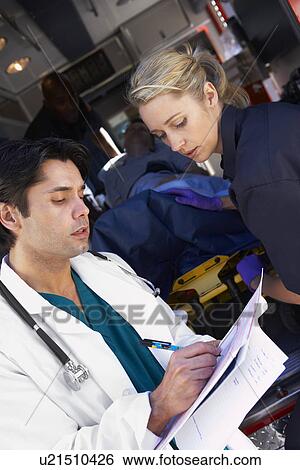 Stock Photograph - Paramedic advising doctor about arriving patient. Fotosearch
