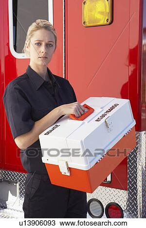 Paramedic standing by ambulance with medical kit View Large Photo Image Stock Image - Paramedic standing by ambulance with medical kit. Fotosearch