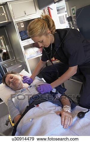 Paramedic with patient in ambulance View Large Photo Image Stock Photo - Paramedic with patient in ambulance. Fotosearch