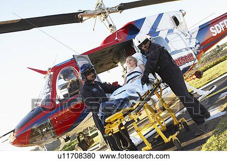 Paramedics unloading patient from Medevac View Large Photo Image Stock Image - Paramedics unloading patient from Medevac. Fotosearch
