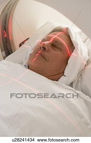 Picture - Patient Having A Computerized Axial Tomography (CAT) Scan. Fotosearch