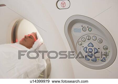 Patient Having A Computerized Axial Tomography (CAT) Scan View Large Photo Image Stock Photo - Patient Having A Computerized Axial Tomography (CAT) Scan. Fotosearch