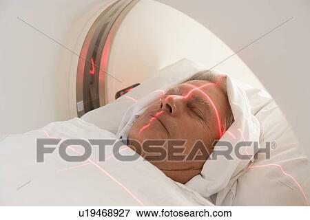 Patient Having A Computerized Axial Tomography (CAT) Scan View Large Photo Image Stock Photo - Patient Having A Computerized Axial Tomography (CAT) Scan. Fotosearch