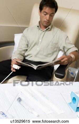Patient Reading A Magazine While Being Monitored View Large Photo Image Stock Photography - Patient Reading A Magazine While Being Monitored. Fotosearch