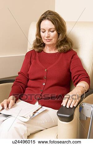 Stock Photography - Patient Reading Magazine While Being Monitored. Fotosearch