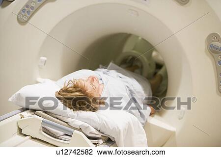 Patient Undergoing For A Computerized Axial Tomography (CAT) Scan View Large Photo Image Stock Image - Patient Undergoing For A Computerized Axial Tomography (CAT) Scan. Fotosearch