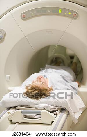 Stock Image - Patient Undergoing For A Computerized Axial Tomography (CAT) Scan. Fotosearch