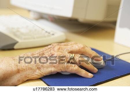 Stock Image - Person using computer. Fotosearch