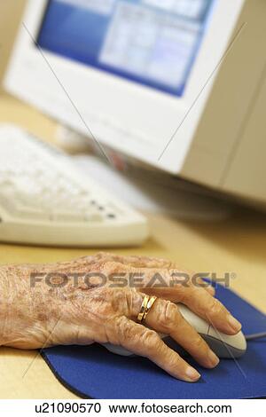 Stock Image - Person using computer. Fotosearch