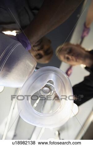 Stock Photo - Personal perspective of paramedics administering oxygen. Fotosearch