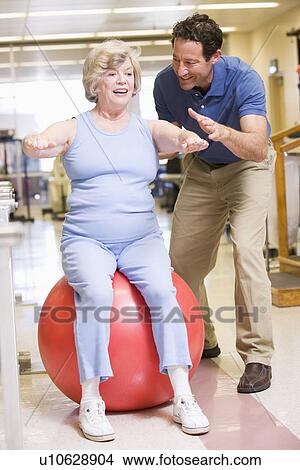 Picture - Physiotherapist With Patient In Rehabilitation. Fotosearch