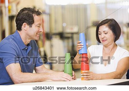 Stock Image - Physiotherapist With Patient In Rehabilitation. Fotosearch