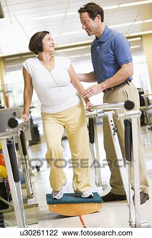 Stock Image - Physiotherapist With Patient In Rehabilitation. Fotosearch