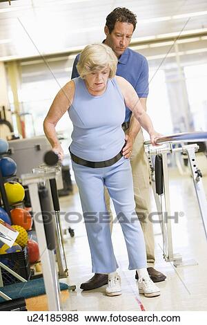 Stock Photo - Physiotherapist With Patient In Rehabilitation. Fotosearch