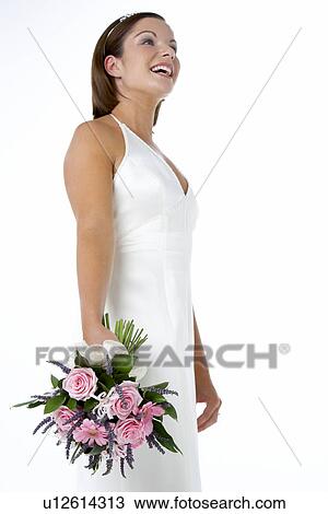 Stock Image - Portrait Of Bride Holding Bouquet Of Flowers. Fotosearch