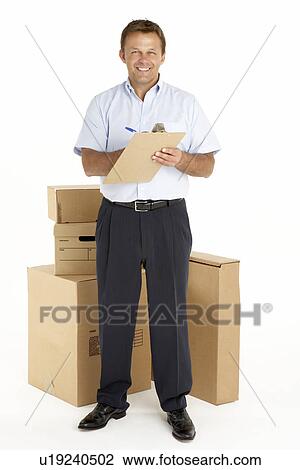 Portrait Of Courier Standing Next To Parcels, Holding A Clipboard View Large Photo Image Stock Image - Portrait Of Courier Standing Next To Parcels, Holding A Clipboard. Fotosearch