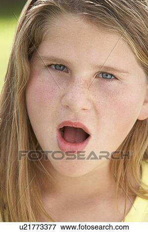 Stock Photo - Portrait Of Girl Looking Shocked. Fotosearch