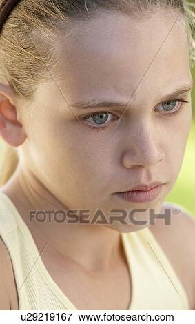 Stock Photo - Portrait Of Girl Looking Upset. Fotosearch