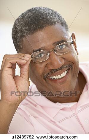 Portrait Of Middle Aged Man Trying On Glasses View Large Photo Image Stock Image - Portrait Of Middle Aged Man Trying On Glasses. Fotosearch