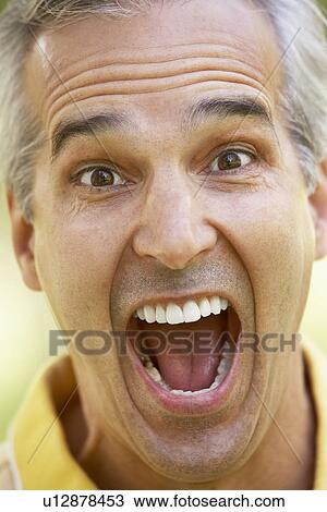 Stock Image - Portrait Of Middle Aged Man With His Mouth Open In Surprise. Fotosearch