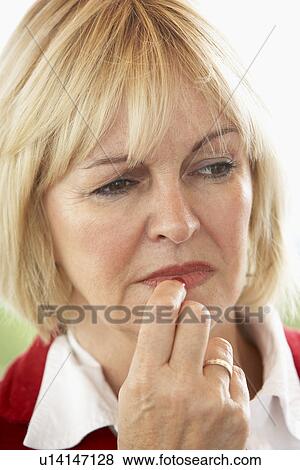 Stock Photo - Portrait Of Middle Aged Woman Frowning. Fotosearch