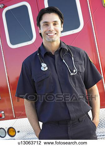 Portrait of paramedic in front of ambulance View Large Photo Image Stock Image - Portrait of paramedic in front of ambulance. Fotosearch