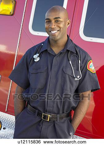 Portrait of paramedic in front of ambulance View Large Photo Image Stock Photograph - Portrait of paramedic in front of ambulance. Fotosearch