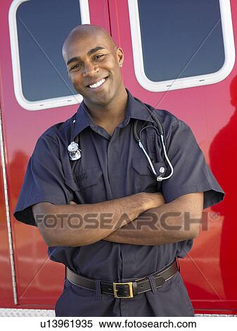 Portrait of paramedic in front of ambulance View Large Photo Image Stock Photography - Portrait of paramedic in front of ambulance. Fotosearch