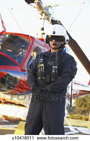 Stock Image - Portrait of paramedic standing in front of Medevac. Fotosearch