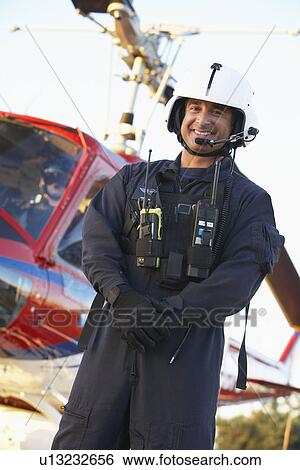 Stock Photograph - Portrait of paramedic standing in front of Medevac. Fotosearch