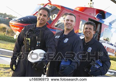 Stock Image - Portrait of paramedics standing in front of Medevac. Fotosearch