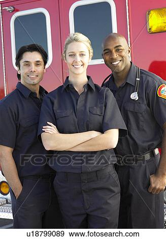Portrait of paramedics standing in front of an ambulance View Large Photo Image Stock Photo - Portrait of paramedics standing in front of an ambulance. Fotosearch