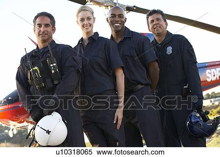 Stock Photography - Portrait of paramedics standing in front of Medevac. Fotosearch