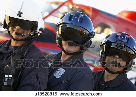 Stock Photography - Portrait of paramedics standing in front of Medevac. Fotosearch