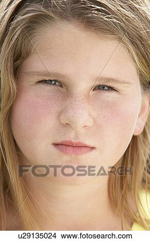 Picture - Portrait Of Pre-Teen Girl Sulking. Fotosearch