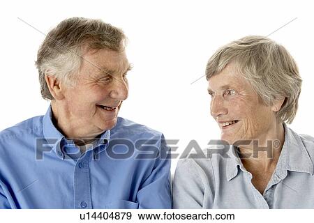 Stock Photo - Portrait of senior couple smiling at each other. Fotosearch